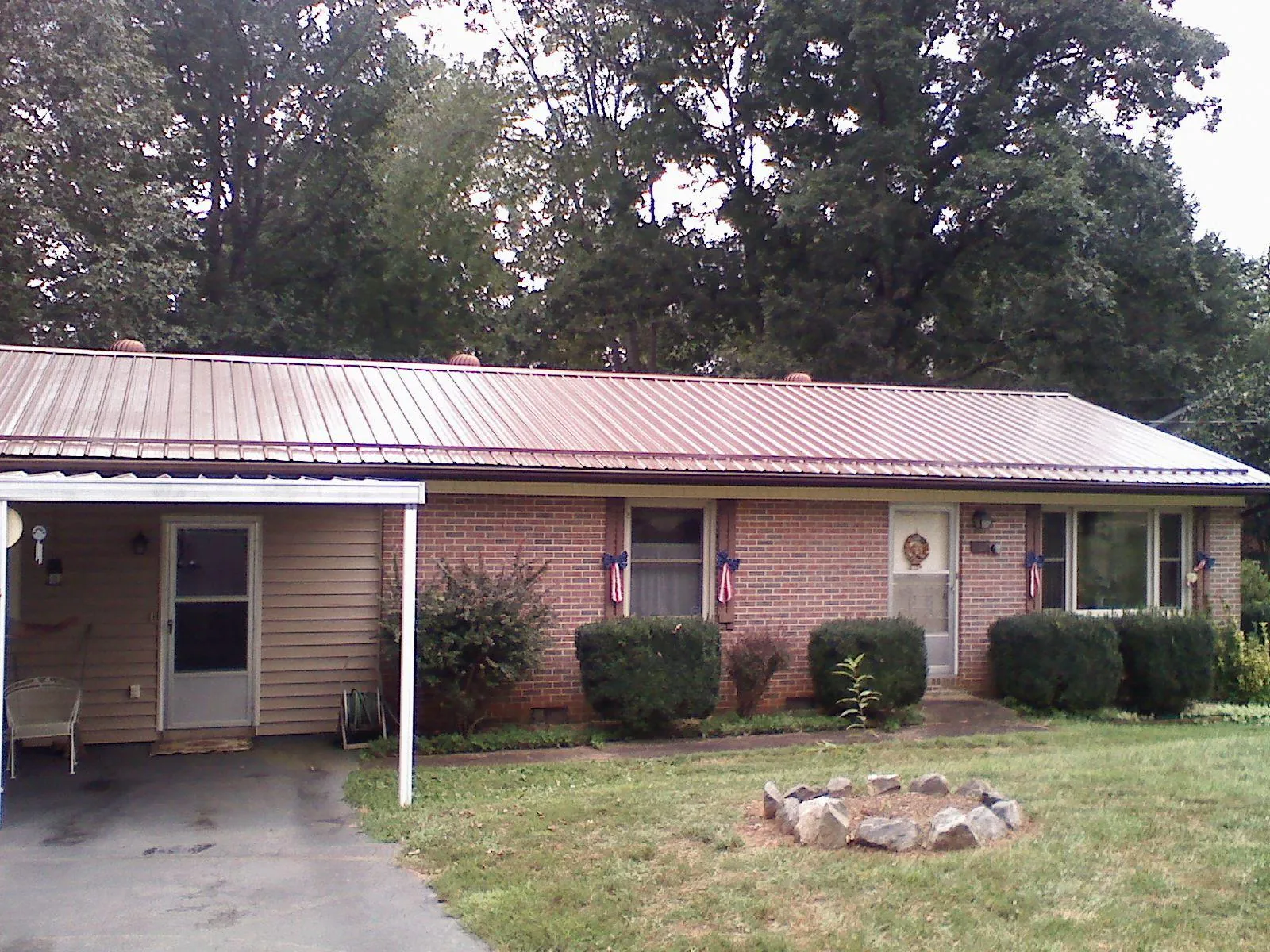 Bronze metal roof and carport on a brick ranch home — Roof Repair work by our crew in Camden